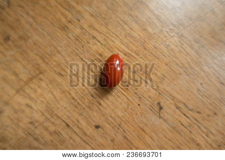 Red Lutein Capsule On Wood From Above