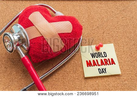 World Malaria Day April 25, Healthcare And Medical Concept. Stethoscope, Handmade Red Heart, Thermom