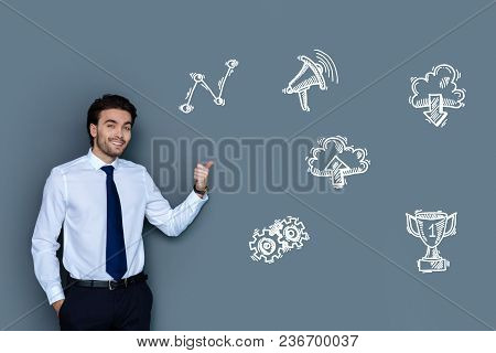 Successful Businessman. Cheerful Young Businessman Feeling Confident And Smiling While Talking About