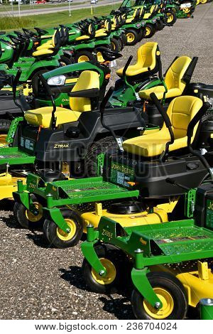 Hawley, Minnesota, August 22, 2017: A Row Of Green And Yellow New Riding Lawn Mower Tractors Are Pro
