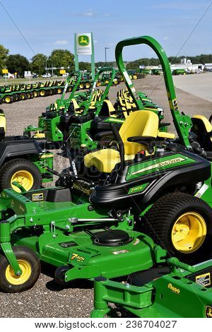 Hawley, Minnesota, August 22, 2017: A Row Of Green And Yellow New Riding Lawn Mower Tractors Are Pro