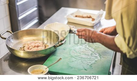 Male Chef Preparing Fish Sauce For Dinner Service - Man Cooking Inside Restaurant Kitchen - Focus On