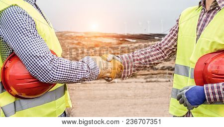 Builders On Wind Farm And Photovoltaic Plant Site Making A Deal - Happy Workers Are Satisfied Of The