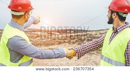 Builders On Wind Farm And Photovoltaic Plant Site Making A Deal - Happy Workers Are Satisfied Of The