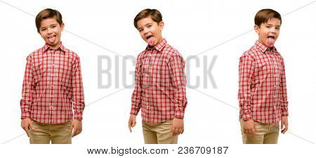 Handsome toddler child with green eyes sticking out tongue at camera at sign of disobedience, protest and disrespect