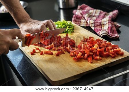 Chef Chopping Red Pepper On A Wooden Board