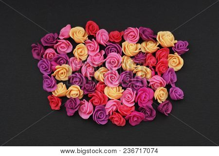 Mix Of Pink And Peach Fake Plastic Mini Rosess Flowers Black Background Copy Space. Craft, Art,