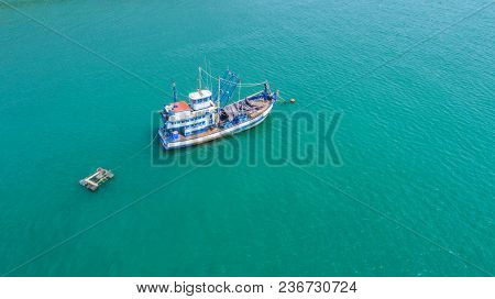 Fishing Boat Floating In The Sea. The Beautiful Bright Blue Water In A Clear Day.aerial View.top Vie
