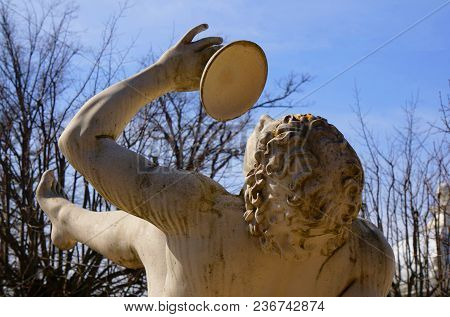Statue Of Bacchus In Park. Spring Park Blue Background.