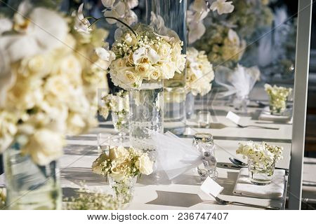The Wedding Reception Dinner Venue Setup With The White Flower Theme, A Bunch Of White Roses, Flower