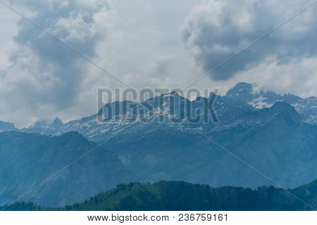 The Tops Of The Picturesque Mountains Are Covered With White Snow.