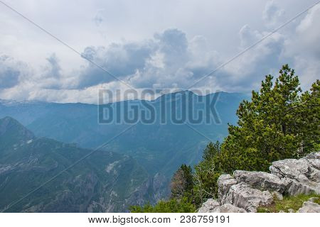 The Tops Of The Picturesque Mountains Are Covered With White Snow.