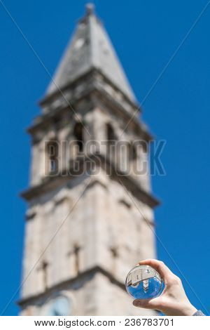Saint Nikola Church Tower Reflected In A Glass Ball Held By A Tourist, Perast, Kotor Harbor, Montene
