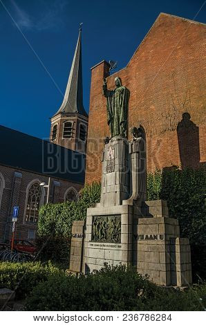 Tielt, Western Belgium - July 02, 2017. Monument, Brick Building Facade And Tower At Sunset In The C