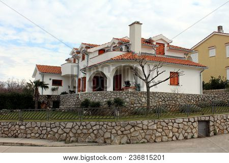 Modern White Mediterranean Villa On Street Corner Surrounded With Traditional Stone Wall, Metal Fenc