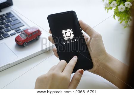 Chiang Mai,thailand - Feb 18, 2018 : A Woman Hand Holding Uber App Showing On New Mobile Samsung Gal