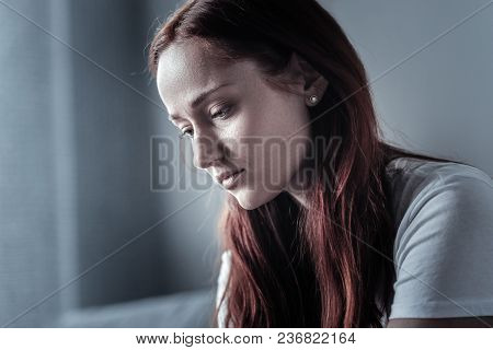 No Motivation. Tragic Deplorable Sad Woman Gazing Down And Experiencing Difficult Times While Posing
