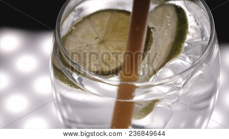 Carbonated Water In A Transparent Glass, Lime, Bubbles, Black Background