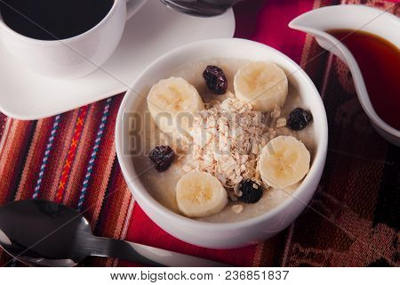 Delicious And Healthy Breakfast, With Banana, Oat Flakes, Raisins, Honey And Black Coffee