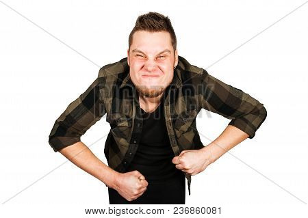 Young Guy With Beard And Modern Hairstyle, Grimaces With Clenched Fists, Isolated On White Backgroun