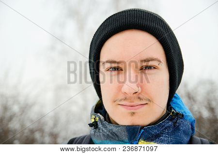 Close Up Portrait Of Young Guy In Hat On Trees Blur Background