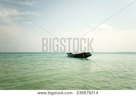 Native Dominican Republic Island Wooden Fishing Boat With Oars Left At Anchor Off Sandy Shores And S