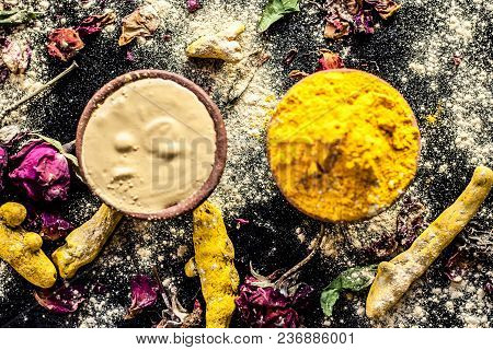 Ayurvedic Ubtan Of Haldi With Holy Rose Water And Fuller’s Earth On Wooden Surface For Good, Brighte