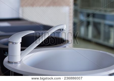 Modern Kitchen And Bathroom Water Faucets In The Store. Selective Focus. There Is Free Space For Tex