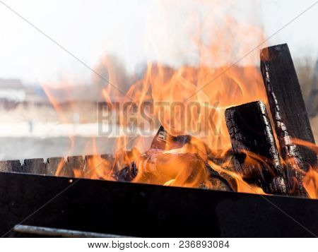 Fire From Burning Wood In The Grill Outdoors