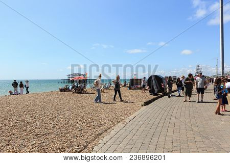 Brighton, United Kingdom - August 1, 2017: Tourists Admire The Amazing View Of English Channel And T