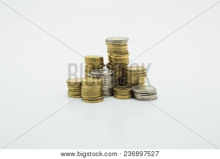 Stack Of Gold And Silver Coins Isolated On White Background With Clipping Path. Growing And Saving M