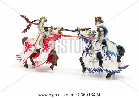 Joust Of Toy Medieval Knights. Isolated On White Background. Toy Horse Knights Tournament