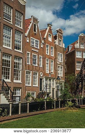 Semidetached Typical Houses And Green Garden At Begijnhof, A Medieval Semi-monastic Community In Ams