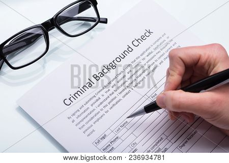 Person Filling Criminal Background Check Form