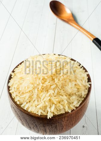 Parboiled Rice Groats In A Wooden Bowl On A Light Background