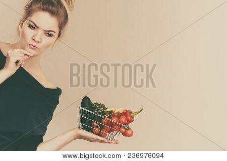 Adult Woman With Raw Food, Questioning Healthy Lifestyle Recommendations, Origin Vegetagles. Female 