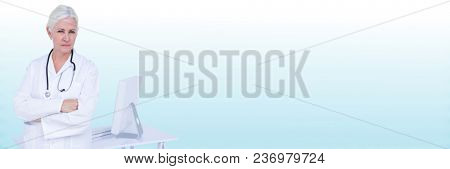 Doctor arms folded against light blue blurred background