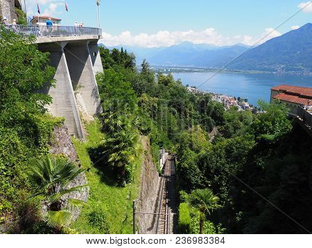 Lake Maggiore With Funicular Railway And Bridge Above Swiss City Locarno At Canton Ticino In Switzer