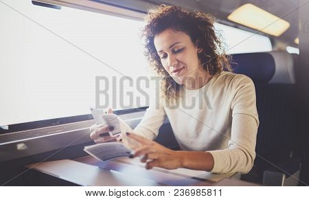 Enjoying Business Travel Concept. Young Beautiful Brunette Tourist Girl Travelling On The Train Sitt