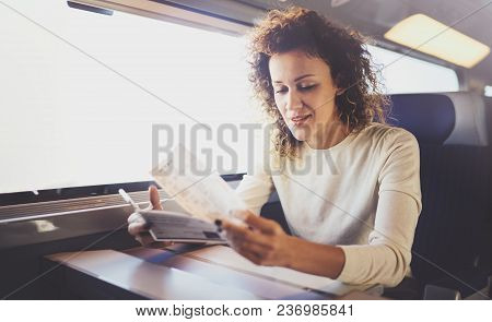 Enjoying Business Travel Concept. Young Beautiful Brunette Tourist Girl Travelling On The Train Sitt