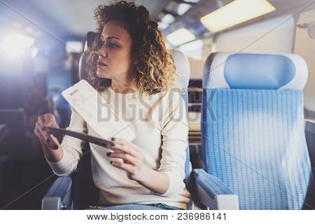 Enjoying Business Travel Concept. Young Beautiful Brunette Tourist Girl Travelling On The Train Sitt