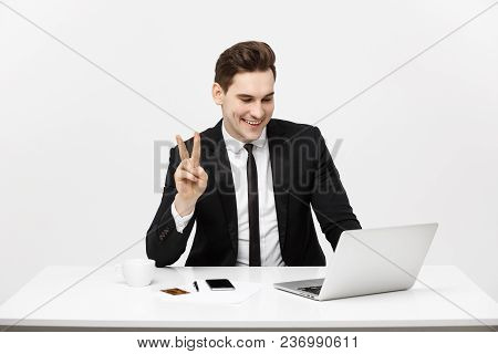 Young Businessman Facetime With Someone And Showing Two Finger Or Victory Finger Sign.