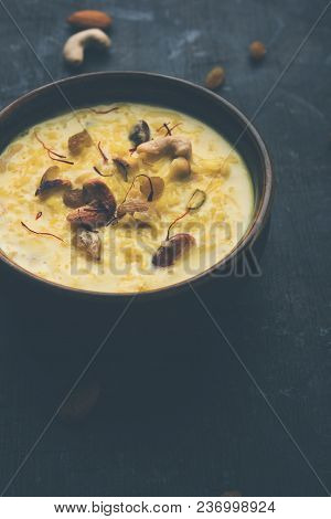 Kheer Or Rice Pudding Is An Indian Dessert In A Brown Terracotta Bowl With Dry Fruits Toppings