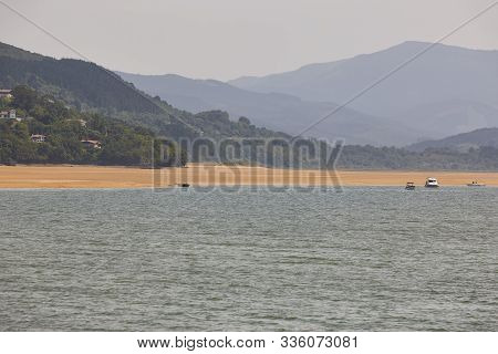 Spanish Coastline And Mountains In Basque Country. Mundaka Beach. Spain