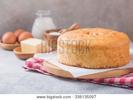Homemade  Soft And Lite Delicious Sponge Cake With Ingredients: Eggs Flour Milk On Stone Concrete Ta