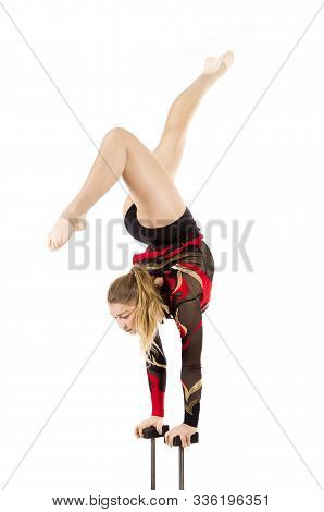 Beautiful Equilibrist In A Red And Black Suit, Performs Exercises On Acrobatic Canes.