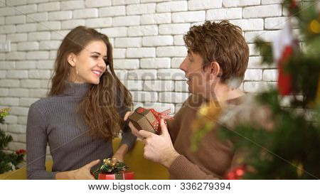 White Couple Exchange Presents For Holiday Season