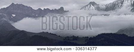 Alpine Landscape With Forest Ridge, Mountains And Clouds