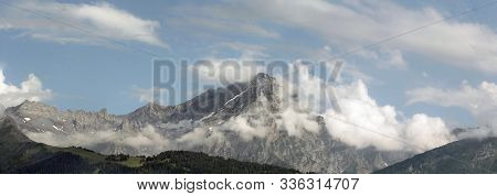 Alpine Landscape With Mountain And Clouds In Summer