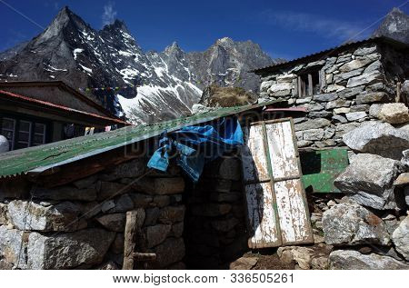 Hiking in Nepal Himalayas, Old stone buildings seen on the way from Namche to Gokyo in small Lhabarma village